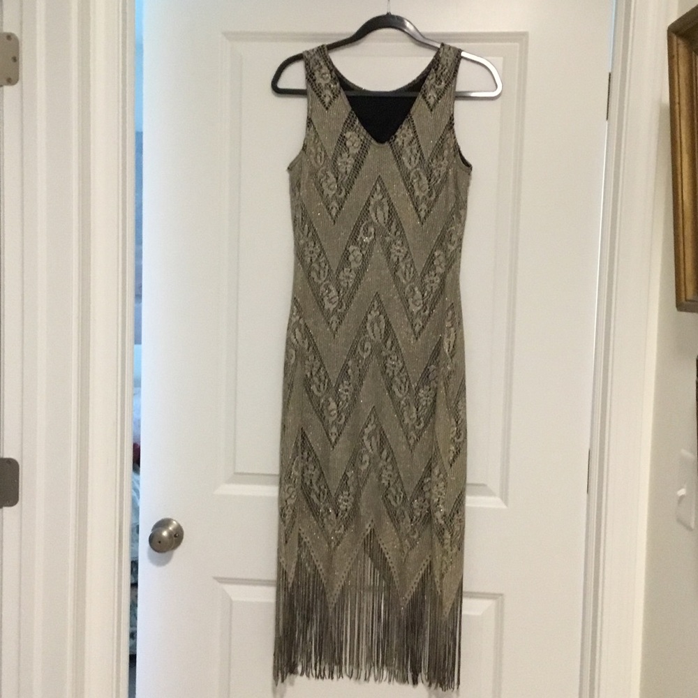 Gold lacy dress with lining and a fringe hem